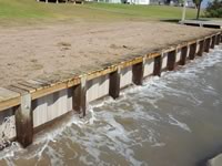 Vinyl Bulkhead with 2x6x16 piano key top cap. - Port Alto Texas - Replacement on old wooden Bulkhead. Used existing piling and new top whaler and tiebacks.