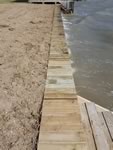 Vinyl Bulkhead with 2x6x16 piano key top cap. - Port Alto Texas - Replacement on old wooden Bulkhead. Used existing piling and new top whaler and tiebacks.