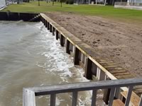 Vinyl Bulkhead with 2x6x16 piano key top cap. - Port Alto Texas - Replacement on old wooden Bulkhead. Used existing piling and new top whaler and tiebacks.