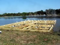 Pier built on private pond with 3 in. PVC pipe for post