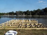 Pier built on private pond with 3 in. PVC pipe for post